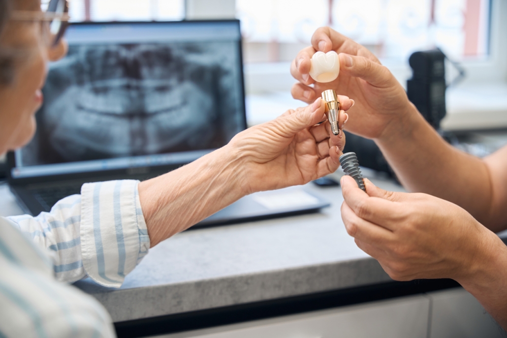 Doctor and patient consulting about dental implant